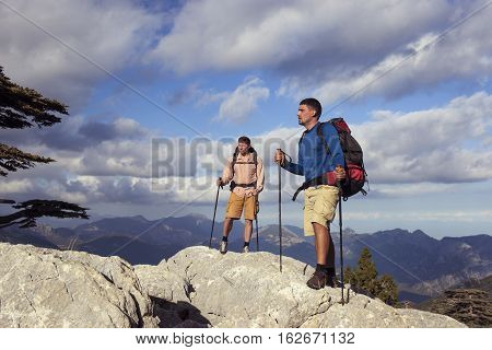 Summer hiking in the mountains with a backpack .