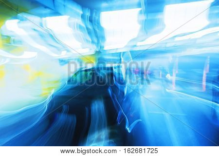 Abstract long exposure motion blur image of black car in underground garage
