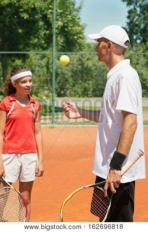 Tennis Instructor And Teenage Student