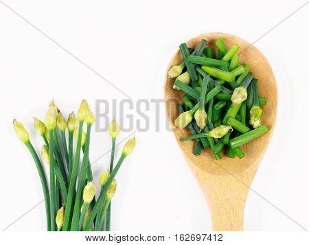 bunch of fresh chives on a wooden cutting board