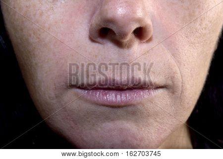Detail of wrinkled lips of a middle-aged woman 40-45 years