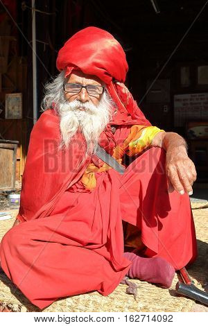 BODHNATH, NEPAL - DECEMBER 24, 2014: Portrait of an old man with a long beard at Ichangu Narayan Temple near Kathmandu