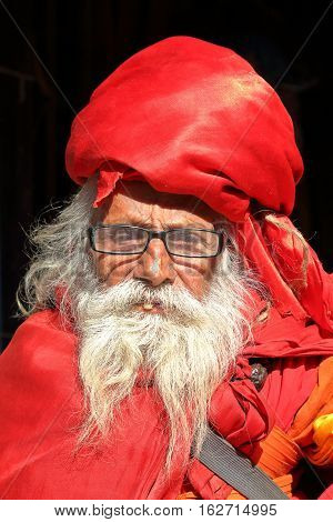 BODHNATH, NEPAL - DECEMBER 24, 2014: Portrait of an old man with a long beard at Ichangu Narayan Temple near Kathmandu