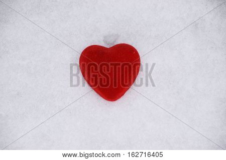 Love red heart on white snow background