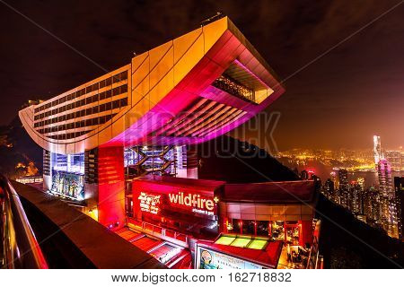 Hong Kong, China - December 7, 2016: The Peak Tower and rooftop restaurant atop Victoria Peak by night. The Peak Tower and spectacular views of Victoria Harbour and skyline of Hong Kong.