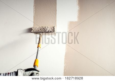 Professional Worker Plastering A Wall, Painting With Paint Brush Decoration On Interior Walls