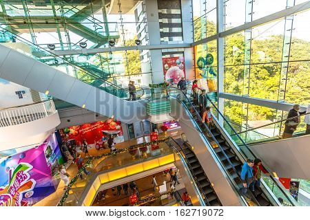 Hong Kong, China - December 10, 2016: People on escalators of the shopping complex Peak Tower, noted for its unusual design, icon of Hong Kong and the Sky Terrace 428, the highest point on the island.