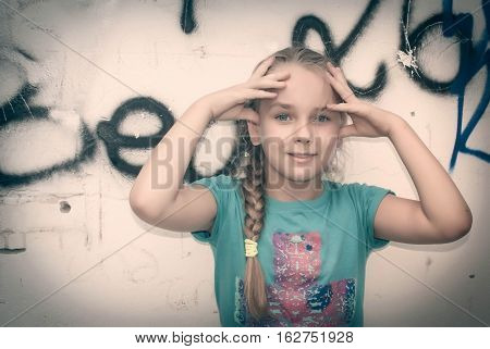 girl posing on wall background very emotional