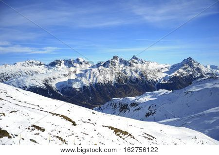 amazing scenic view of snow mountains and ski resort in Switzerland Europe on a cold sunny day with blue sky at Saint Moritz Corvatsch peak in Engadin in winter vacation and holiday concept