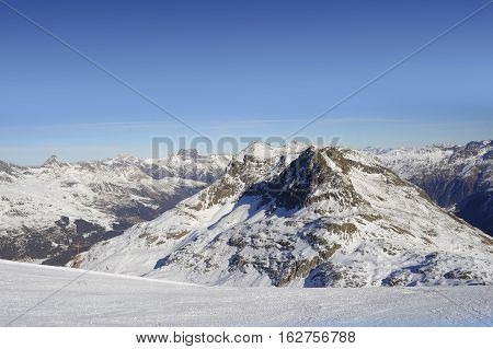 amazing scenic view of snow mountains and ski in Switzerland Europe on a cold sunny day with blue sky at Saint Moritz Corvatsch peak in Engadin in winter vacation and holiday concept