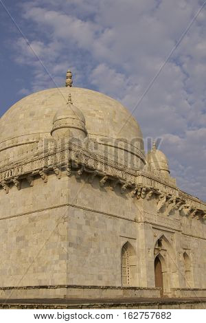 MANDU, MADHYA PRADESH, INDIA - NOVEMBER 19, 2008: Ancient islamic tomb of Hoshang Shah in the hilltop fortress of Mandu in Madya Pradesh, India. White marble building. 15th Century AD
