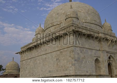 MANDU, MADHYA PRADESH, INDIA - NOVEMBER 19, 2008: Ancient islamic tomb of Hoshang Shah in the hilltop fortress of Mandu in Madya Pradesh, India. White marble building. 15th Century AD