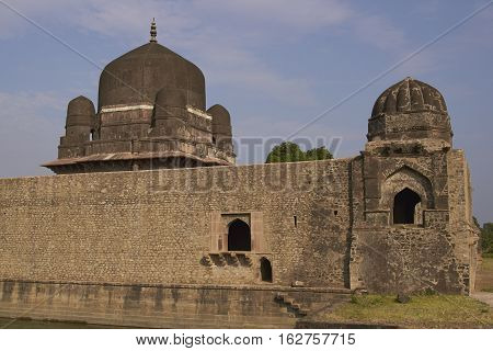 MANDU, MADHYA PRADESH, INDIA - NOVEMBER 18, 2008: Darya Khan's tomb in the hilltop fortress of Mandu. Building with central dome and a smaller dome on each corner in a walled compound. 16th Century AD
