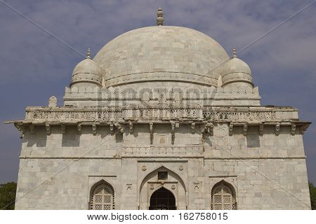 MANDU, MADHYA PRADESH, INDIA - NOVEMBER 18, 2008: Ancient islamic tomb of Hoshang Shah in the hilltop fortress of Mandu in Madya Pradesh, India. White marble building. 15th Century AD