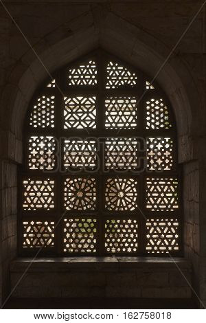 MANDU, MADHYA PRADESH, INDIA - NOVEMBER 18, 2008: Ornate carved screen at the tomb of Hoshang Shah in the hilltop fortress of Mandu in Madya Pradesh, India. White marble building. 15th Century AD