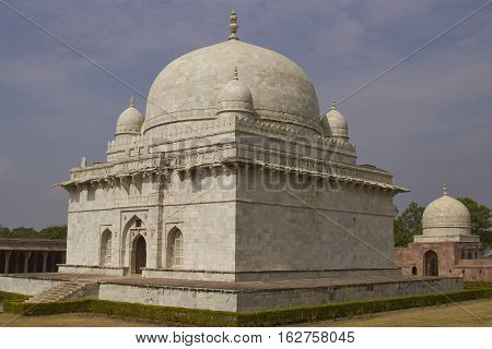 MANDU, MADHYA PRADESH, INDIA - NOVEMBER 18, 2008: Ancient islamic tomb of Hoshang Shah in the hilltop fortress of Mandu in Madya Pradesh, India. White marble building. 15th Century AD