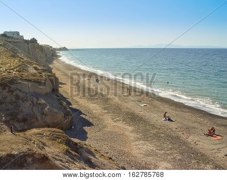 Tourists Enjoying Vlichada Beach On The Island Of Santorini