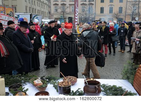 CRACOW POLAND - DECEMBER 18 2016: Christmas Eve for poor and homeless on the Central Market in Cracow. Every year the group Kosciuszko prepares the greatest eve in the open air in Poland