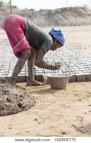 Illustrative image. Pondicherry Tamil Nadu India - July 03 2014. Poor woman worker in small village very hard work for little money roupies