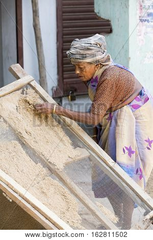 Illustrative image. Pondicherry Tamil Nadu India - July 03 2014. Poor woman worker in small village very hard work for little money roupies