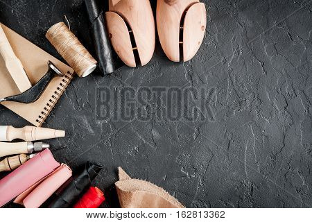 cobbler tools in workshop on dark background top view mock up.