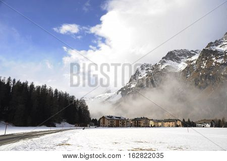 amazing landscape scenic view of Engadin valley in Switzerland Sils Maria village with snow on Alp mountains and frozen ground on a cold sunny winter day in tourism and holiday destination