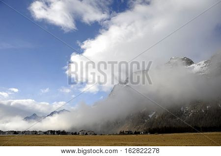amazing landscape scenic view of Engadin valley in Switzerland Sils Maria village with snow on Alp mountains and frozen ground on a cold sunny winter day in tourism and holiday destination