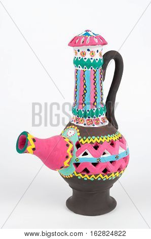 Front view of Nubian style decorated colorful handcrafted pottery jug on white background