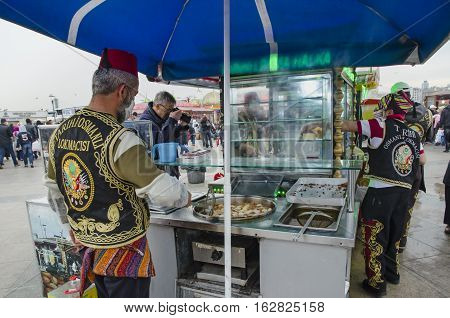 Istanbul Turkey - March 29 2013: Eminonu traditional ottoman bite sweet sellers. There is no denying that desserts are a massive part of Turkish culture. When walking around Istanbul you can see a sweet seller just on almost every corner with mouthwaterin