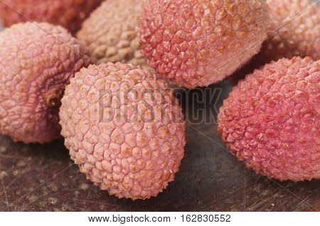 Lychee berries on a timber board close up