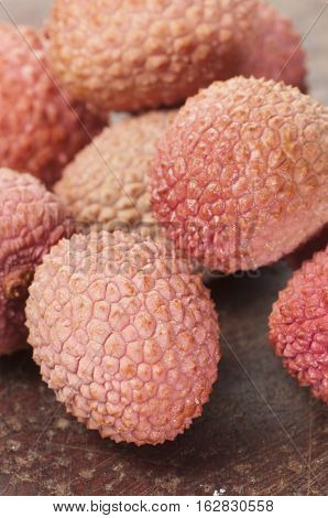 Lychee berries on a timber board close up