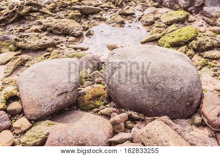 Rock exposed and sea water when low tide at Kalim beach Phuket Thailand. It an be used as background