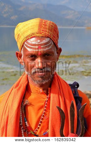 POKHARA, NEPAL - JANUARY 4, 2015: Portrait of a Sadhu or Holy man along the shore of Phewa Lake