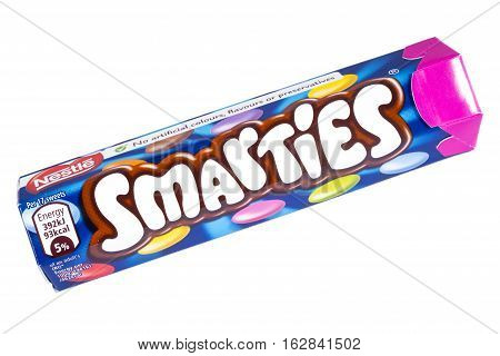 LONDON UK - OCTOBER 13TH 2016: An unopened Smarties chocolate sweets tube manufactured by Nestle pictured over a plain white background on 13th October 2016.