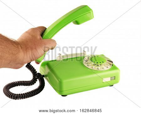 On a white background male hand holding a green telephone handset rotary dialer