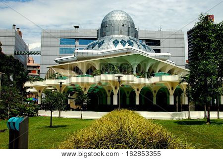 Kuala Lumpur Malaysia - January 1 2008: Modernist Islamic Masjid Asy-Syakirin Mosque in the park at Suria KLCC with its unique silver dome