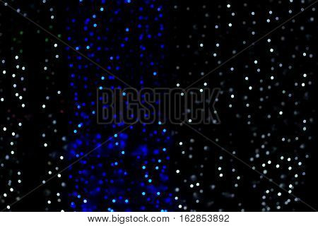 Abstract night background blur of blue and white points of light