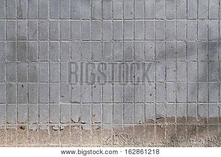 Mosaic tiles on the facade of a house. Architectural background made of blue painted mosaic wall