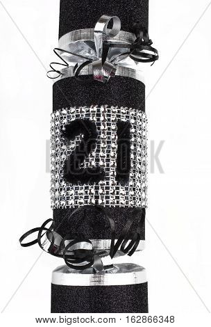 A shot of a 21st Birthday or Anniversary Cracker also known as a Bon Bon. A traditional cracker consists of a cardboard tube wrapped in a brightly decorated twist of paper with a gift in the central chamber.