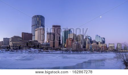 CALGARY, CANADA - DEC 17: Calgary's skyline at sunrise on a cold winter day on December 17, 2016 in Calgary, Alberta. Calgary is home to many oil companies. The Bow River is visible.