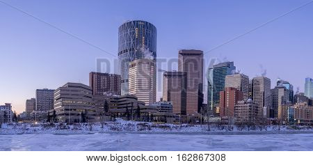 CALGARY, CANADA - DEC 17: Calgary's skyline at sunrise on a cold winter day on December 17, 2016 in Calgary, Alberta. Calgary is home to many oil companies. The Bow River is visible.