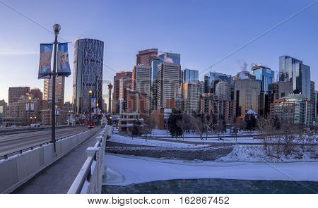CALGARY, CANADA - DEC 17: Calgary's skyline at sunrise on a cold winter day on December 17, 2016 in Calgary, Alberta. Calgary is home to many oil companies. The Bow River is visible.