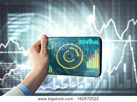Tablet with infographs in business person hand