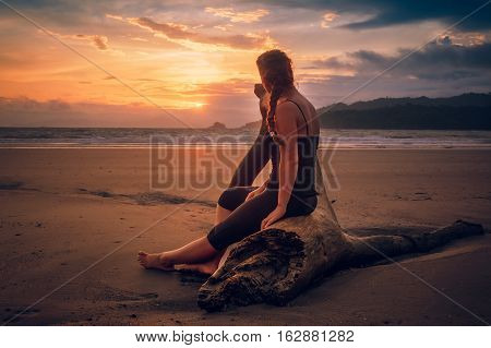 Girl enjoying a beautiful sunset on the beach