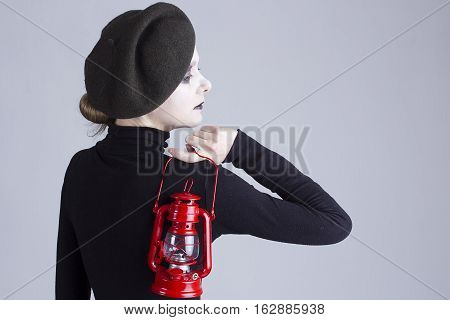 Young beautiful woman mime with red lantern