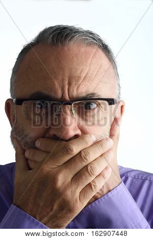 Middle-aged man  with hand in mouth on white