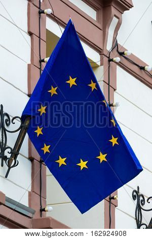 EU flag. European Union flag. Flag attached to the building.