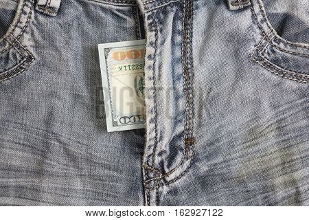 hundred dollar bill inside codpiece blue jeans closeup