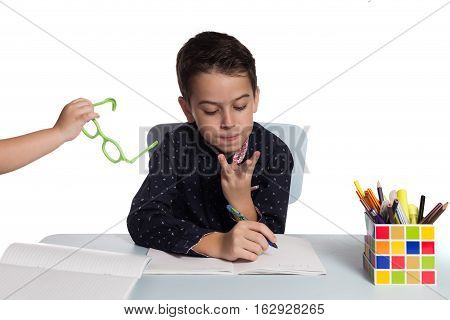 Student doing math calculation. Schoolboy at his desk doing homework.