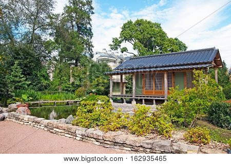 SAINT-PETERSBURG, RUSSIA, AUGUST 3, 2016: Fragment of The Japanese Garden with tea house in Peter the Great Botanical Garden (Botanic Gardens of the Komarov Botanical Institute)